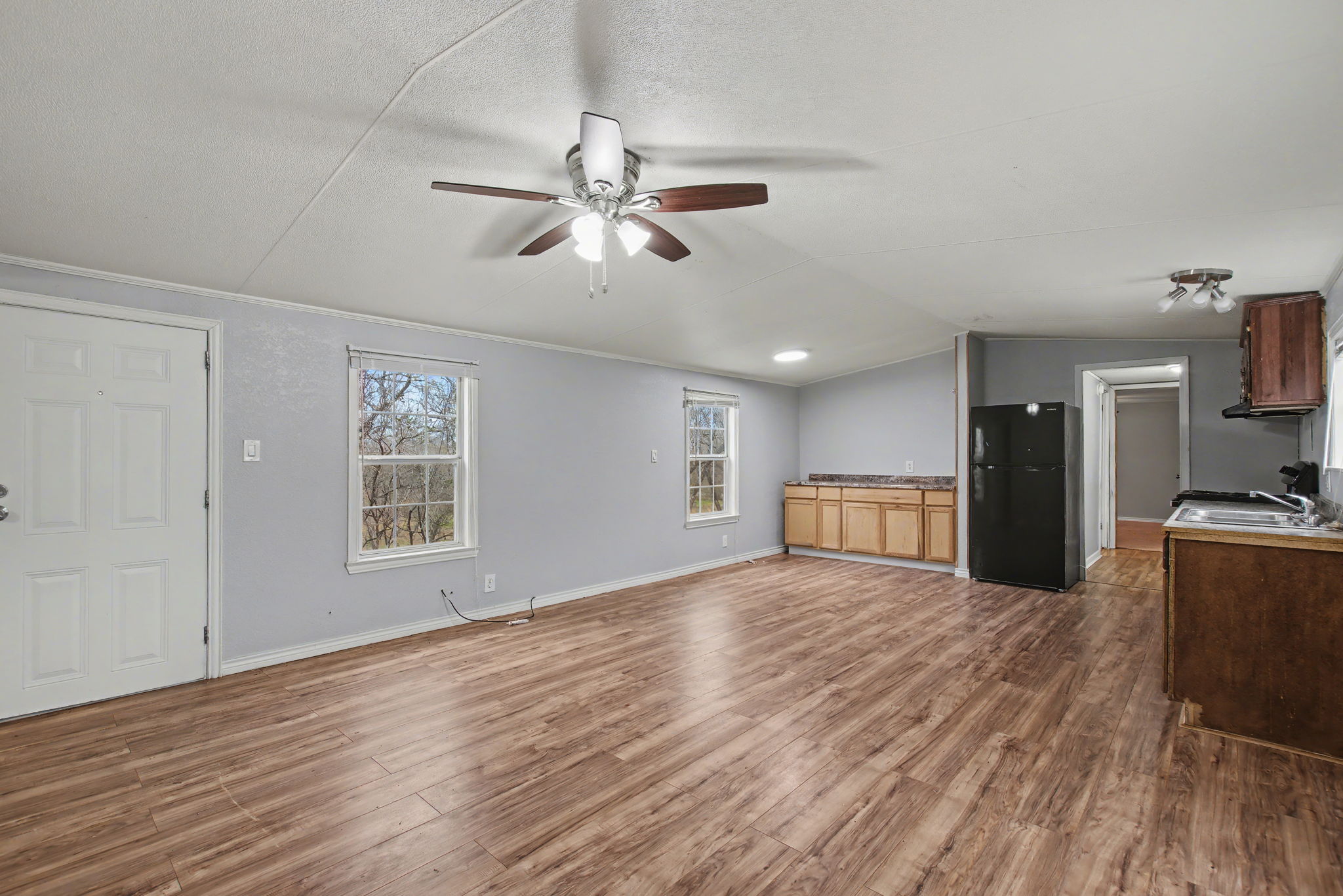 919 Austin Street Kingsland, TX 78639 - Photo 7 of 20 a view of an empty room with a window and wooden floor