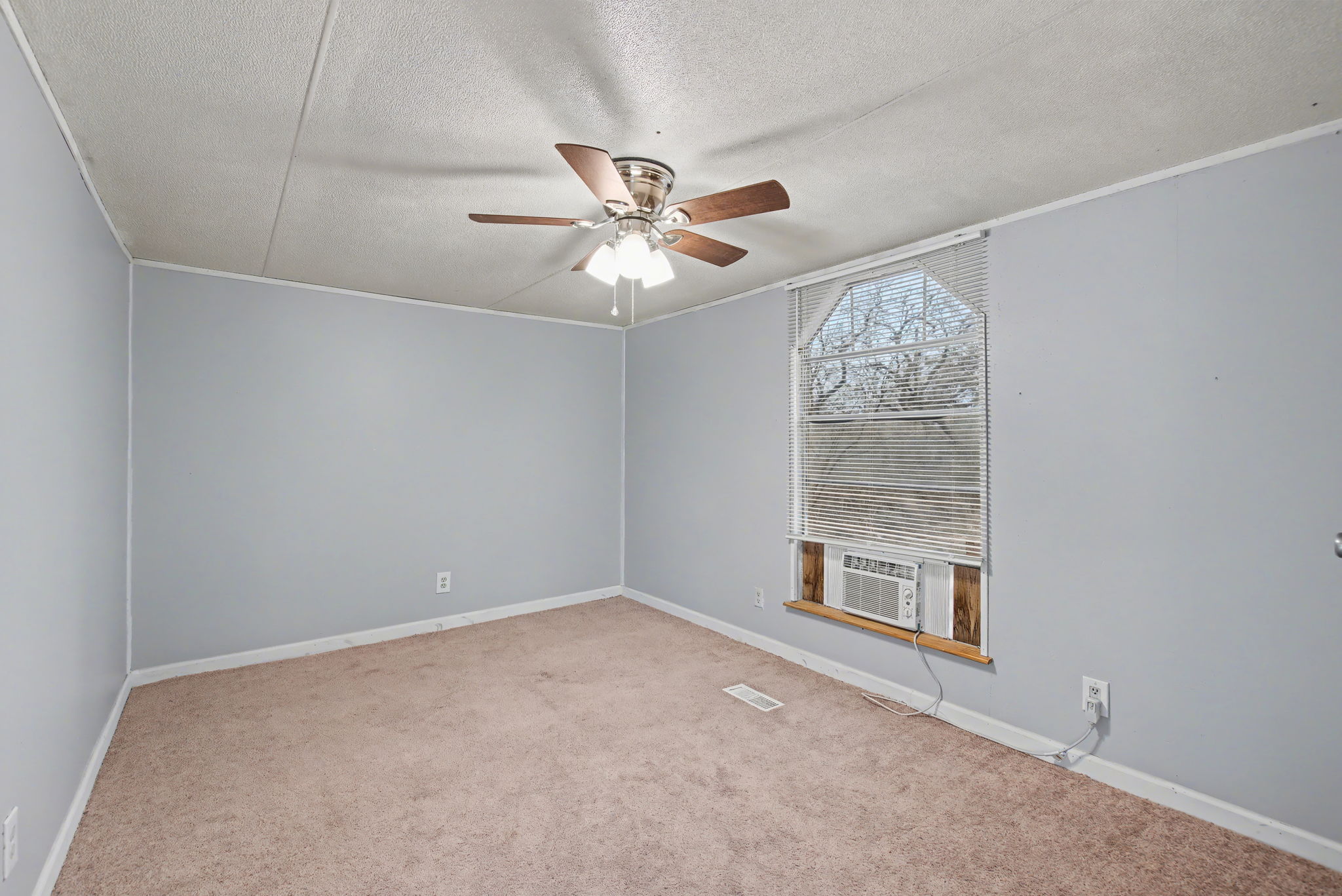 919 Austin Street Kingsland, TX 78639 - Photo 8 of 20 an empty room with windows and fan