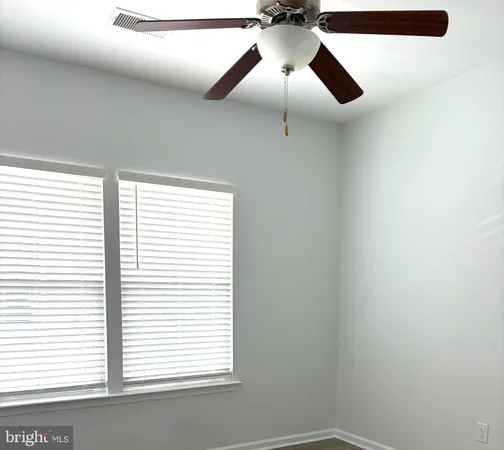 a bathroom with a granite countertop bathtub sink vanity mirror and toilet