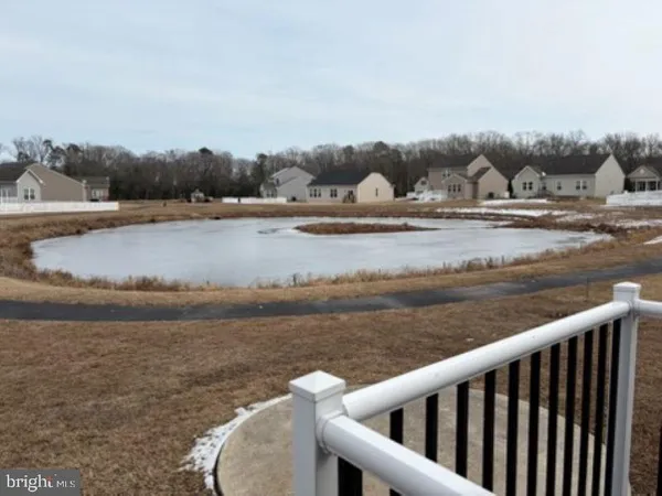 a white building with a white roof and floor to ceiling window
