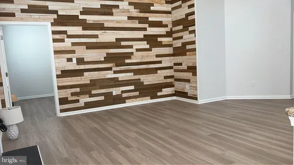 a view of a room with wooden floor