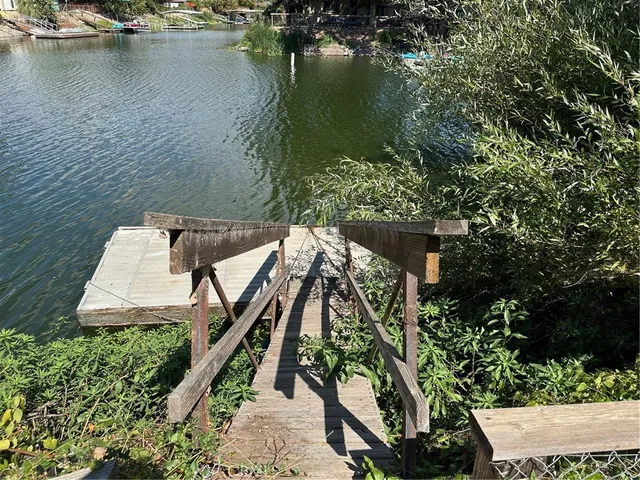 an aerial view of a house with a yard and lake view