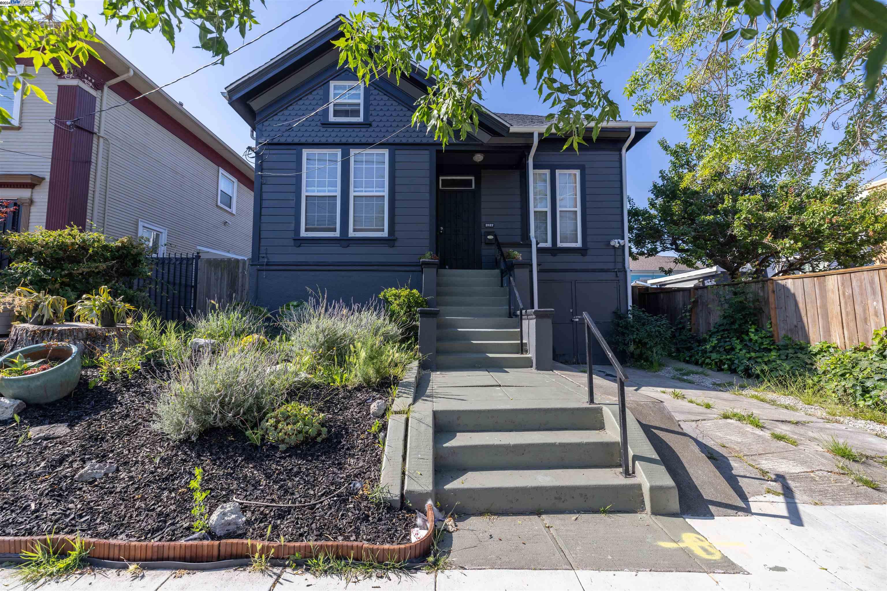 2022 Emerson Street Berkeley, CA 94703 - Photo 1 of 1 a front view of a house with a yard garage and outdoor seating
