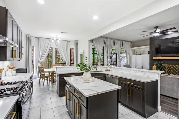 a kitchen with a stove a sink and a refrigerator