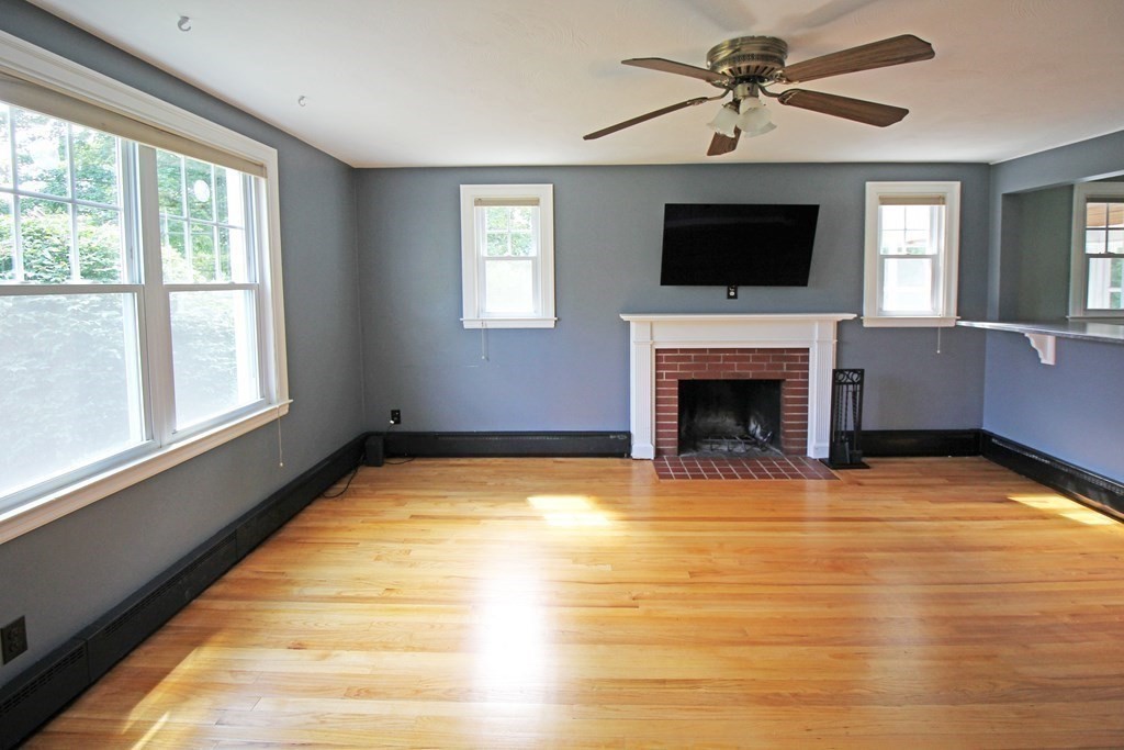 174 Bridge Road Northampton, MA 01062 - Photo 3 of 24 a view of an empty room with a fireplace and a window