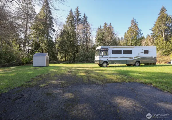 a view of a house with backyard and sitting area