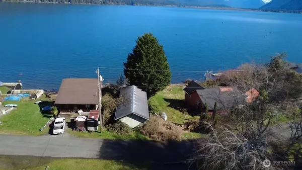 a backyard of a house with table and chairs