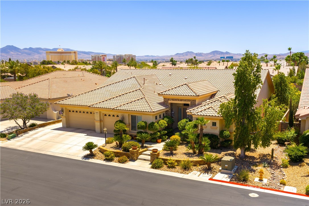 3661 Riley Ann Avenue Las Vegas, NV 89139 - Photo 37 of 42 A well-maintained desert landscape frames this single-story residence with a classic tiled roof.