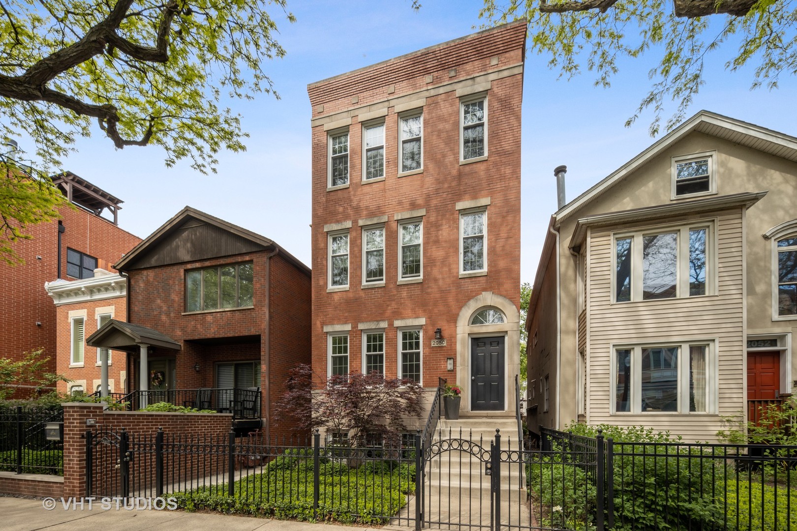 a front view of a residential apartment building with a yard