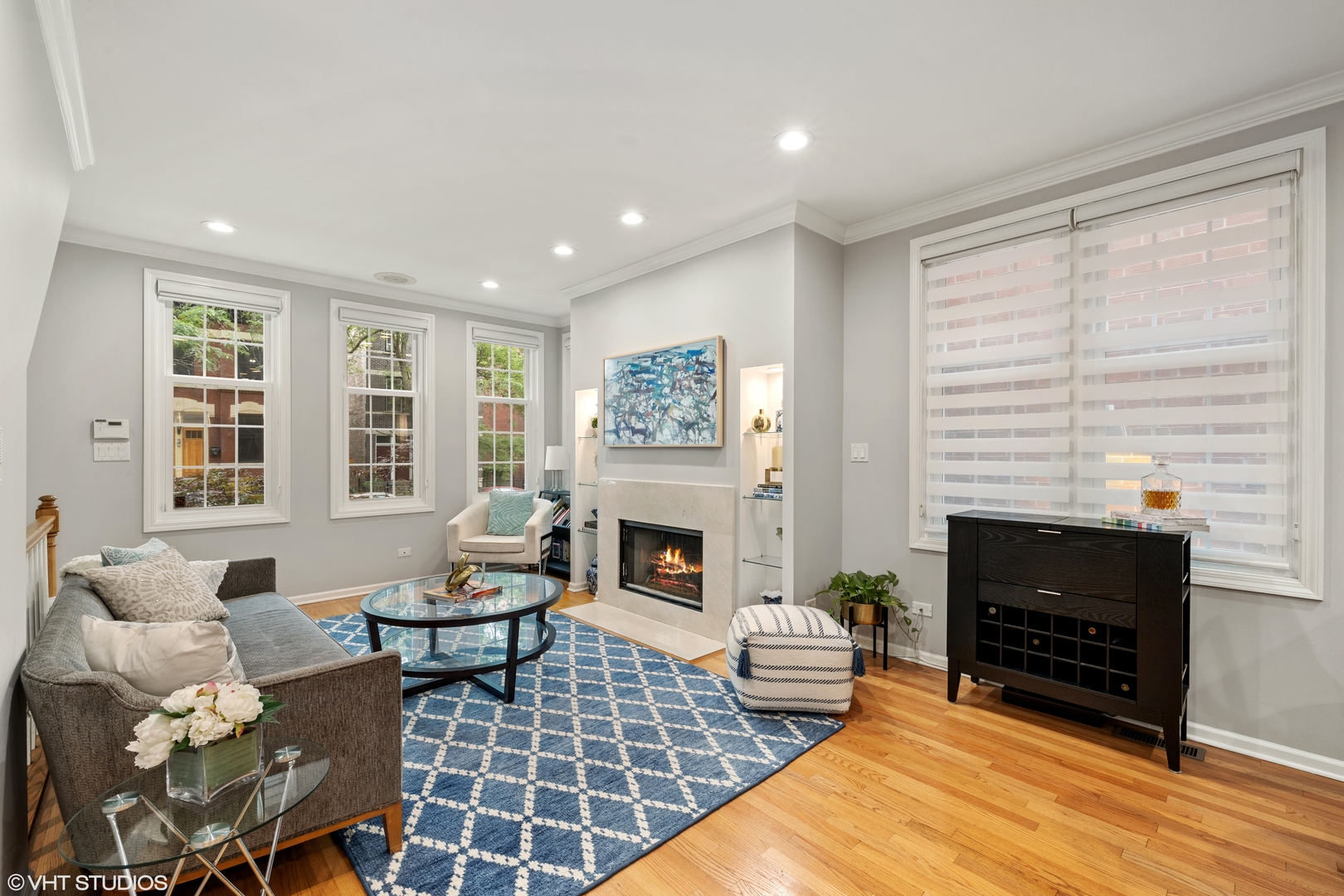 2050 North Racine Avenue, Unit 1 Chicago, IL 60614 - Photo 3 of 25 a living room with furniture a fireplace and a floor to ceiling window