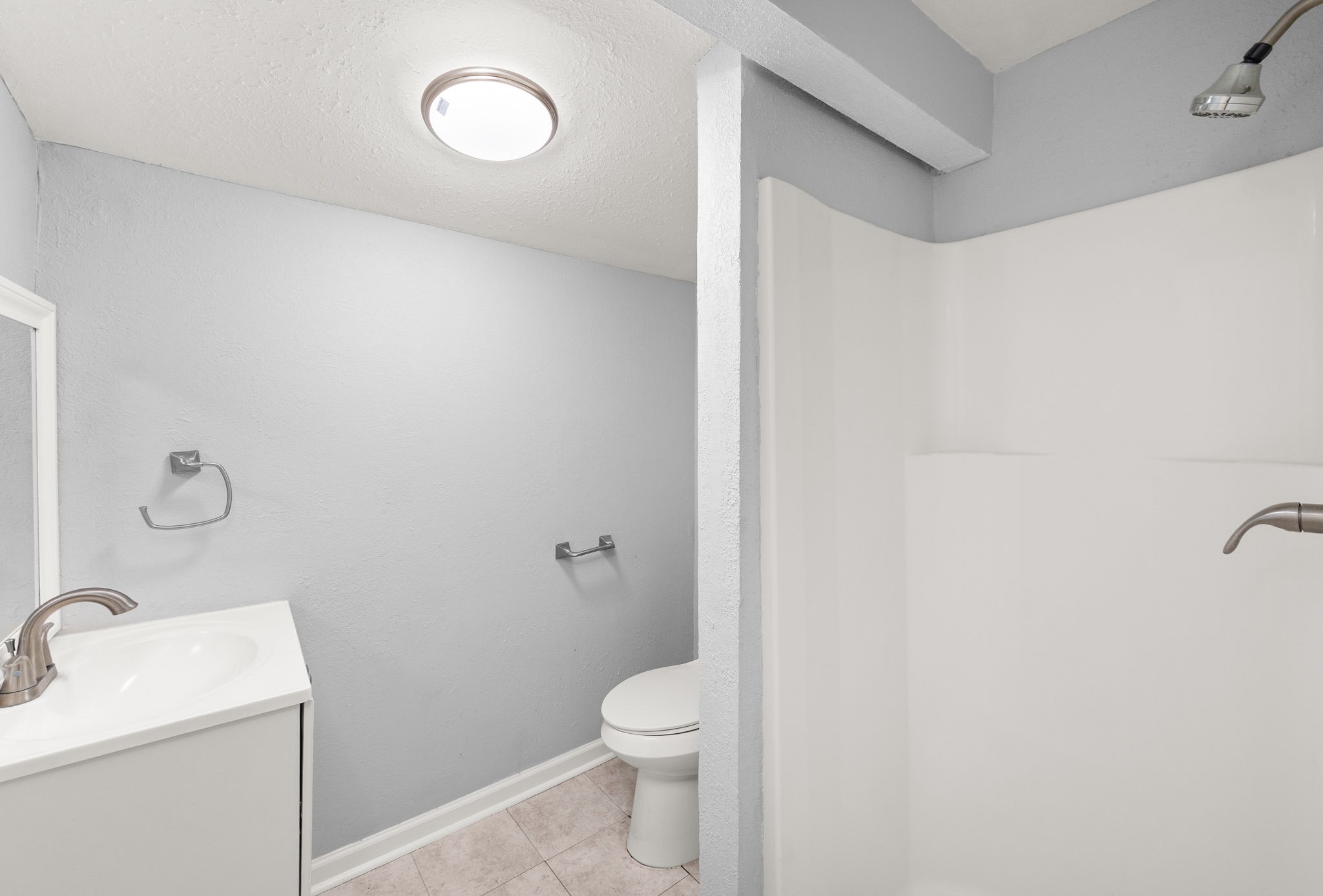 203 South Fig Street Sweeny, TX 77480 - Photo 13 of 20 Modern bathroom featuring a refreshed shower, sink, and toilet.