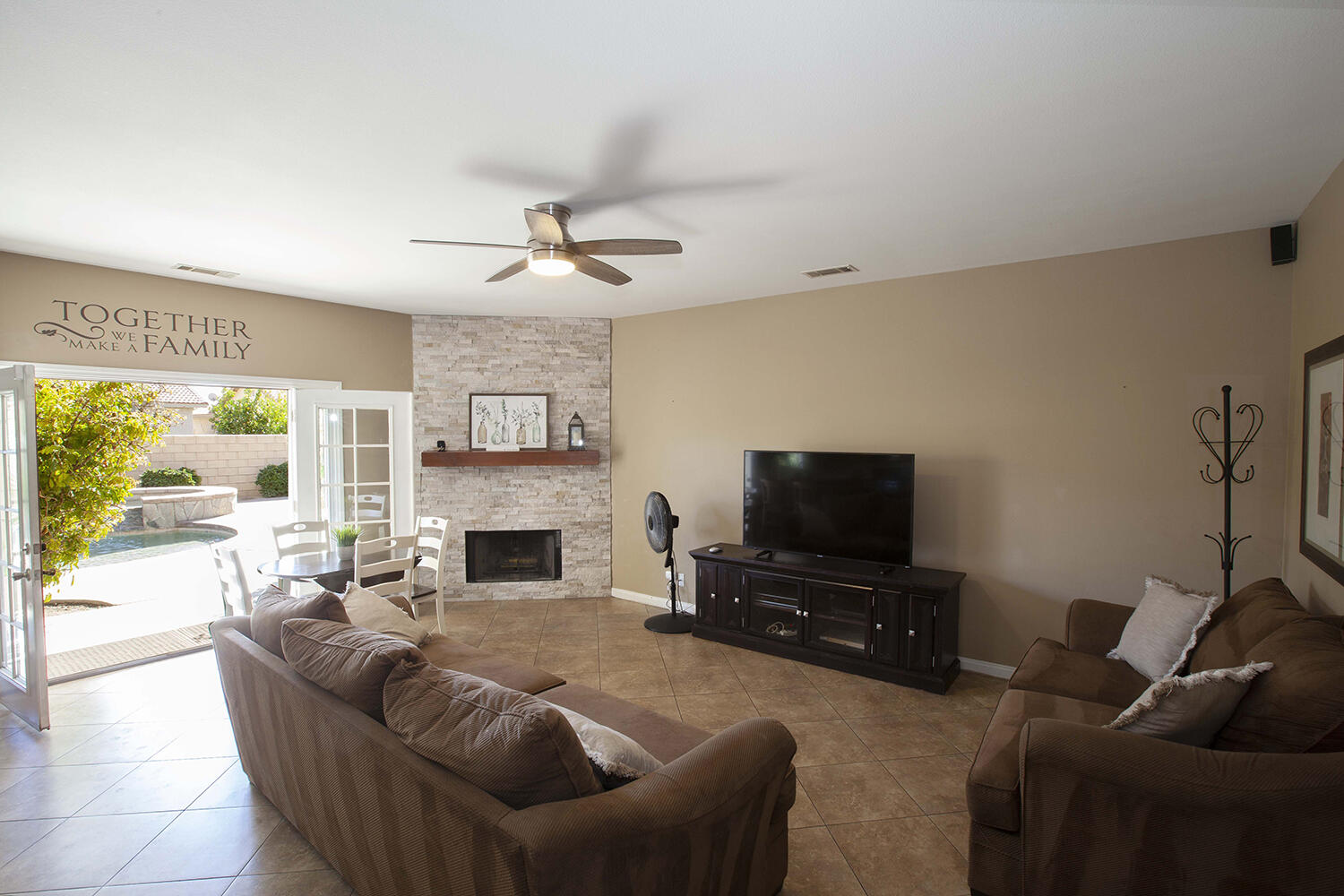 43500 Brahea Court Indio, CA 92201 - Photo 15 of 33 a living room with furniture a fireplace and a flat screen tv