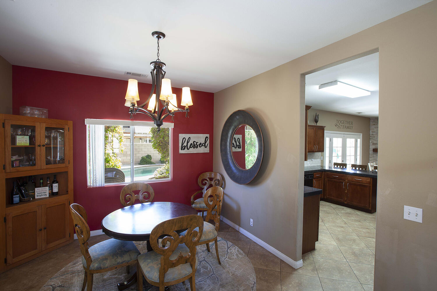 43500 Brahea Court Indio, CA 92201 - Photo 9 of 33 a view of a dining room with furniture a chandelier and wooden floor
