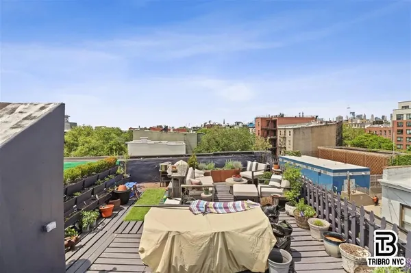 a view of a balcony with dining table and chairs