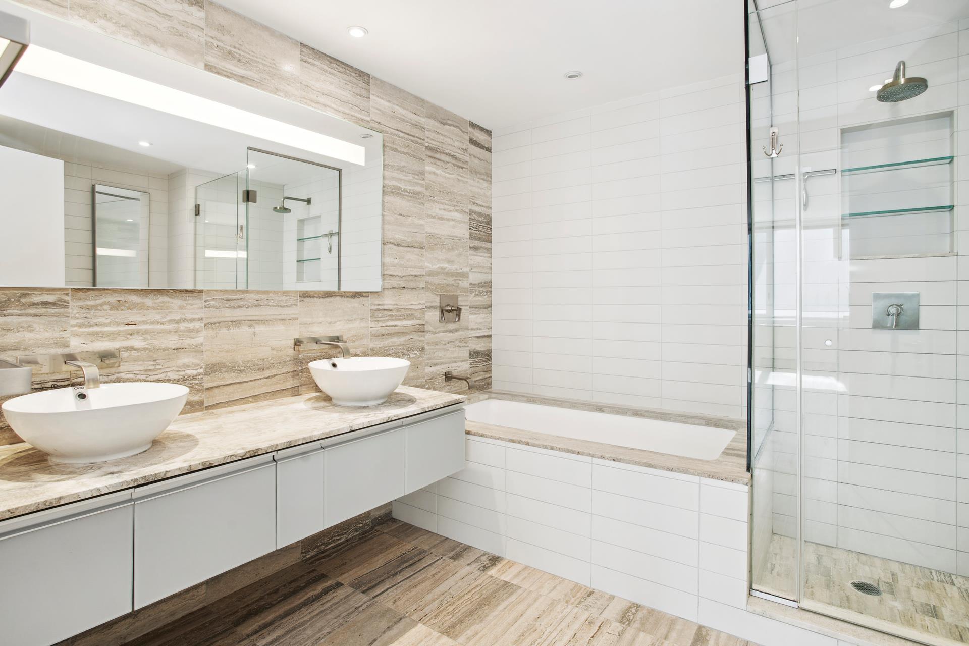 322 West 57th Street, Unit 55S1 Manhattan, NY 10019 - Photo 11 of 33 a bathroom with a double vanity sink and a mirror