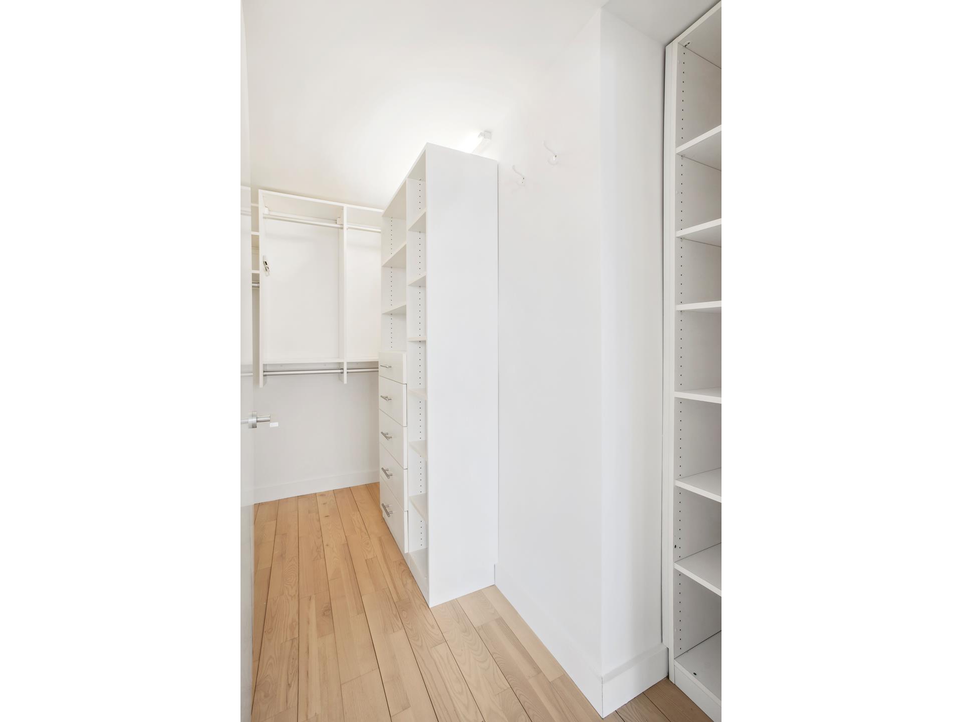 322 West 57th Street, Unit 55S1 Manhattan, NY 10019 - Photo 12 of 33 a view of a hallway with wooden floor