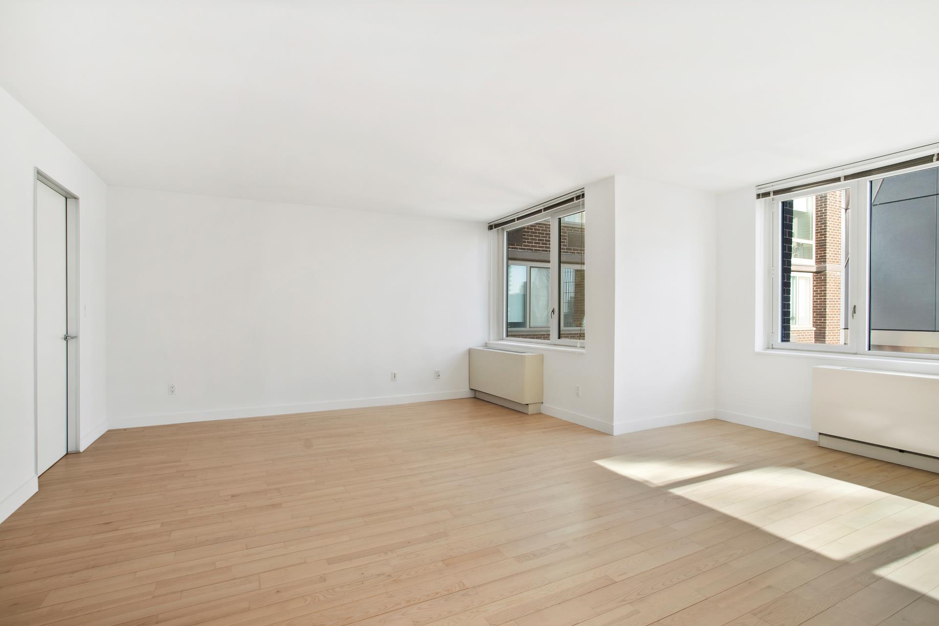 322 West 57th Street, Unit 55S1 Manhattan, NY 10019 - Photo 9 of 33 an empty room with windows