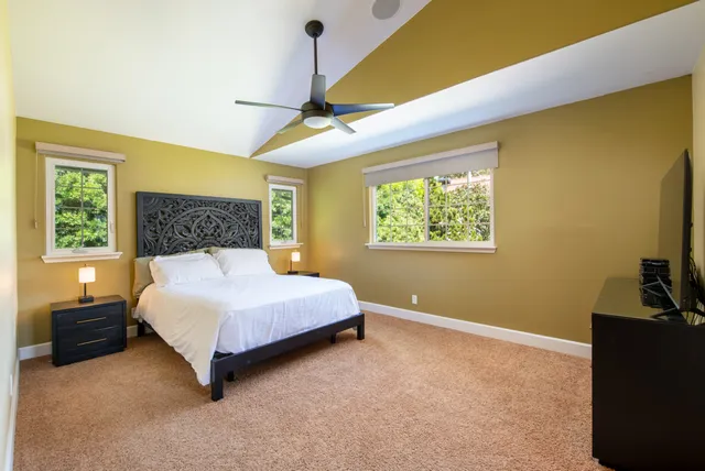 a bedroom with a bed dresser and a window