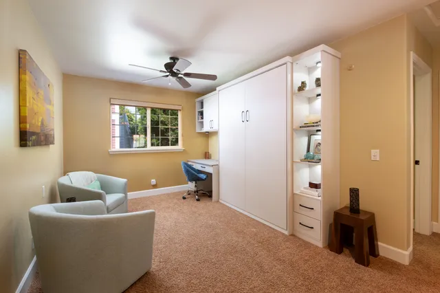 a living room with furniture a chandelier and a window