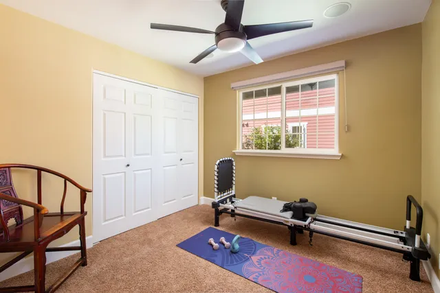 a view of a workspace with furniture and a window