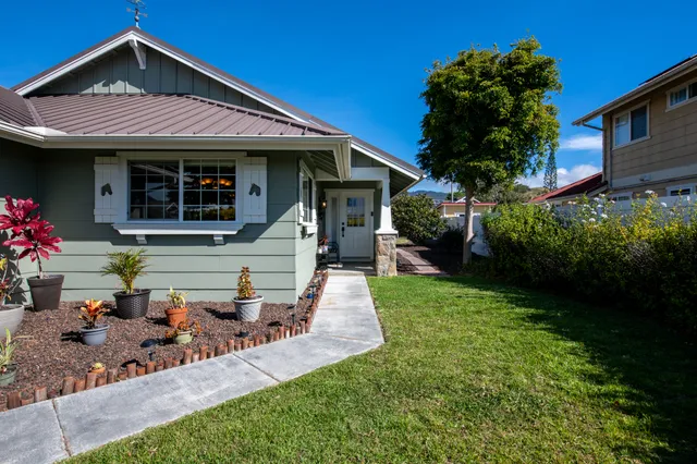 a front view of a house with garden