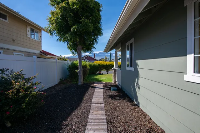 a view of a pathway of a house with a yard