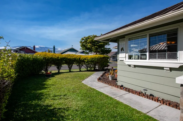 a view of a house with a yard balcony and outdoor seating