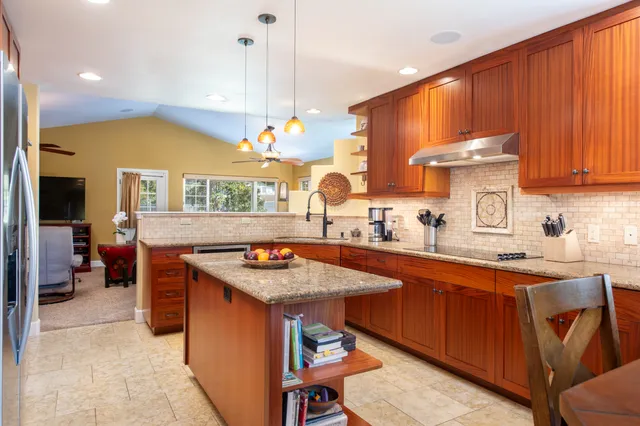 a kitchen with a sink a counter and chairs