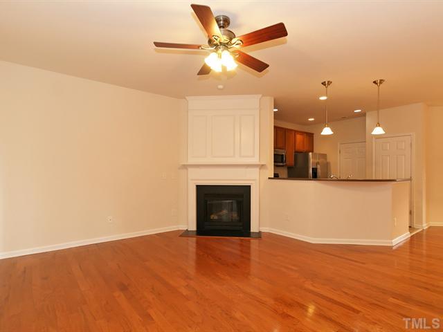 7122 Racine Way Raleigh, NC 27615 - Photo 6 of 20 Stay warm in the living room while relaxing next to the fireplace.