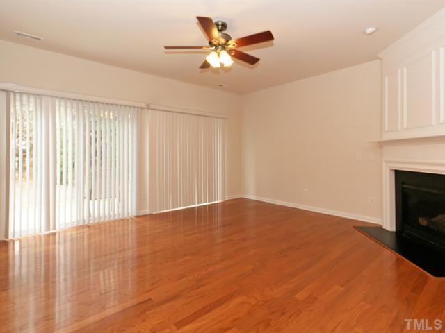 7122 Racine Way Raleigh, NC 27615 - Photo 7 of 20 The living room also features double sliding doors to the back patio.