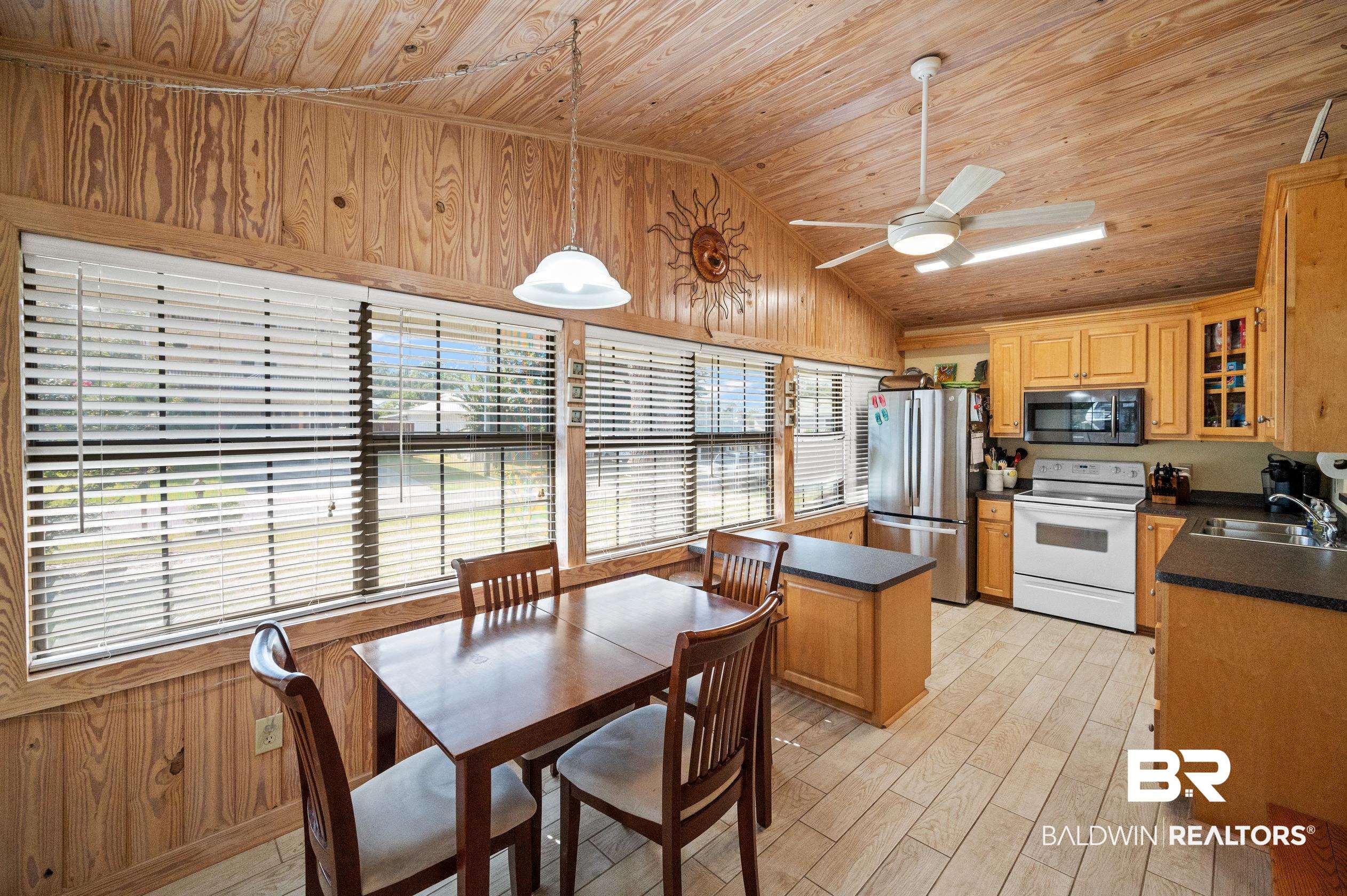 5392 Ornacor Avenue Orange Beach, AL 36561 - Photo 7 of 48 Kitchen featuring decorative light fixtures, appliances with stainless steel finishes, ceiling fan, wood ceiling, and lofted ceiling