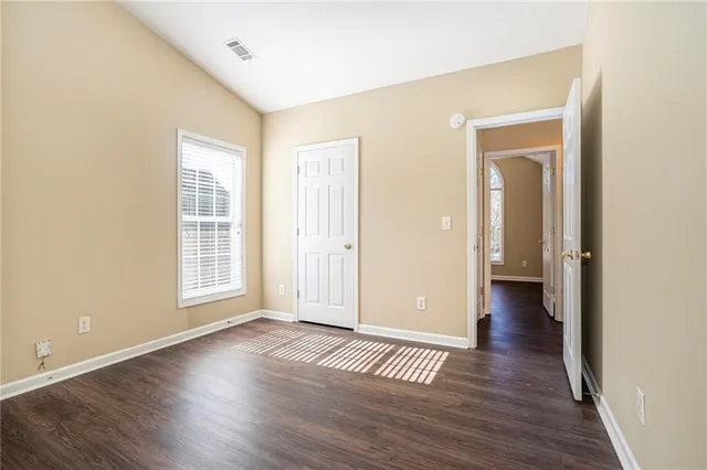 a view of a livingroom with wooden floor and window