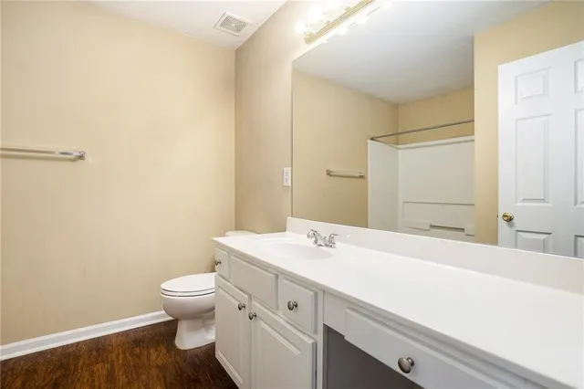 a bathroom with a sink a toilet and mirror