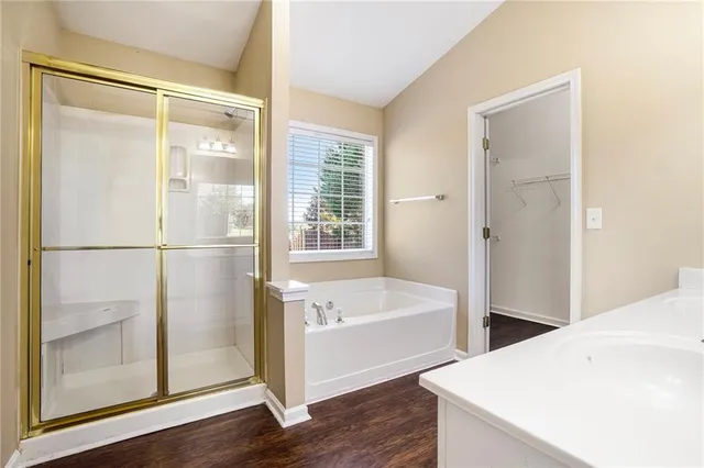 a bathroom with a tub and shower