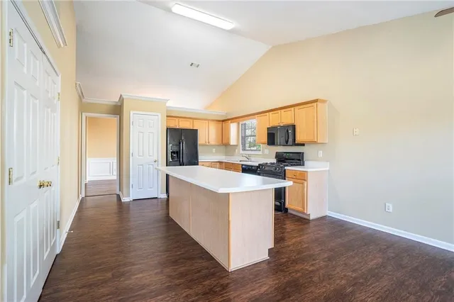 a kitchen with stainless steel appliances granite countertop a stove and a refrigerator