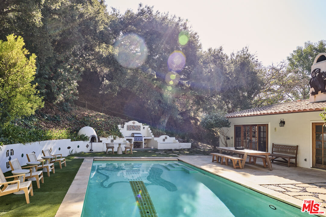 3268 Serra Road Malibu, CA 90265 - Photo 1 of 24 a view of a house with swimming pool and sitting area