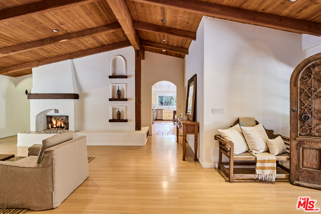 3268 Serra Road Malibu, CA 90265 - Photo 12 of 24 a living room with furniture and a fireplace