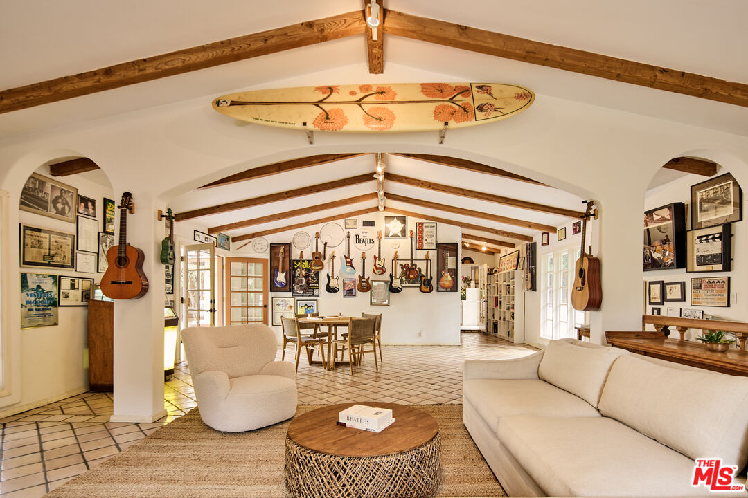 3268 Serra Road Malibu, CA 90265 - Photo 15 of 24 a living room with furniture and a chandelier