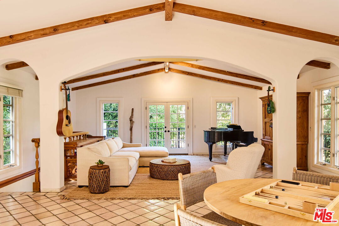 3268 Serra Road Malibu, CA 90265 - Photo 16 of 24 a living room with furniture and a large window