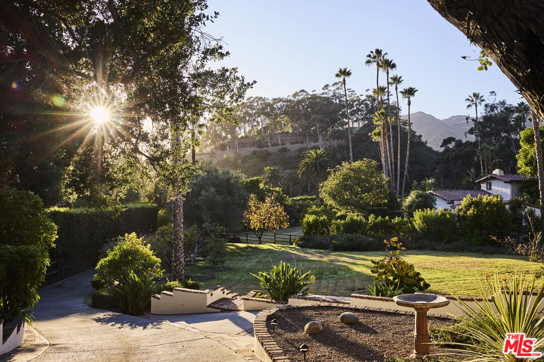 3268 Serra Road Malibu, CA 90265 - Photo 24 of 24 a front view of a house with a yard and lake view