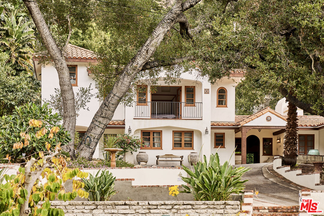 3268 Serra Road Malibu, CA 90265 - Photo 3 of 24 a front view of a house with a garden