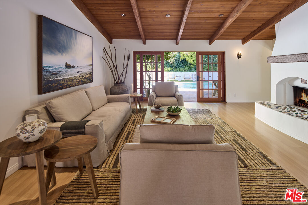 3268 Serra Road Malibu, CA 90265 - Photo 6 of 24 a living room with furniture and a fireplace