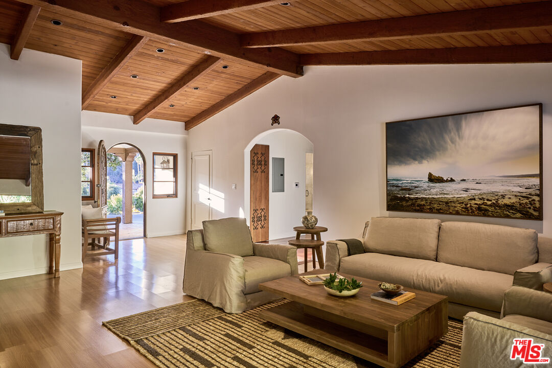 3268 Serra Road Malibu, CA 90265 - Photo 7 of 24 a living room with furniture and wooden floor