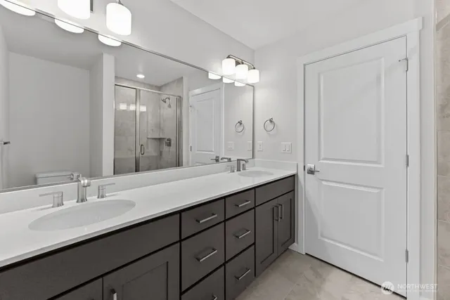a bathroom with a double vanity sink and a mirror