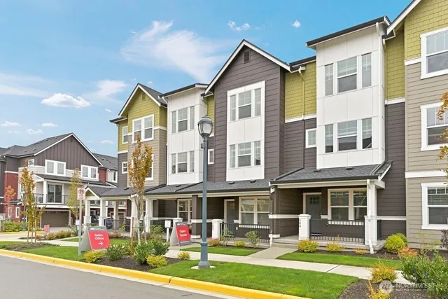 a front view of a residential apartment building with a yard