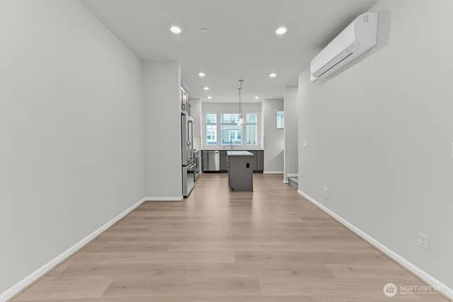 a view of a kitchen with a sink and wooden floor