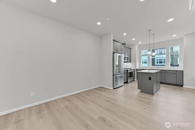 a kitchen with a wooden floor and window