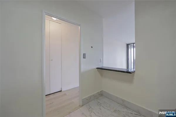 a view of hallway with wooden floor