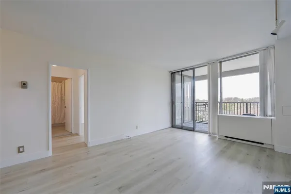 a view of a kitchen with a sink and a refrigerator
