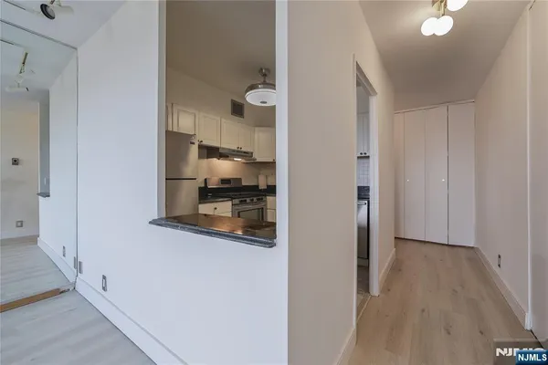 a kitchen with stainless steel appliances granite countertop a sink a stove and cabinets